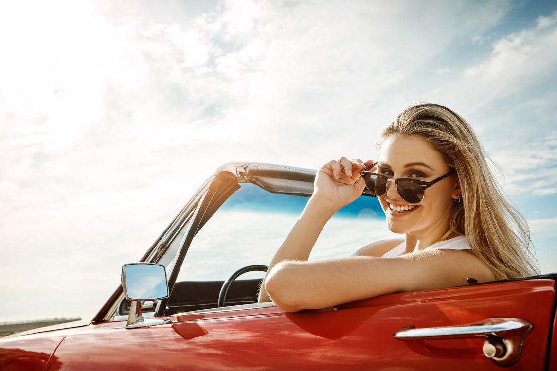 Woman in car with sunglasses